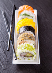 Poster - Delicious sushi pieces served on black stone