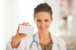 © Alliance - Closeup on happy medical doctor woman showing business card