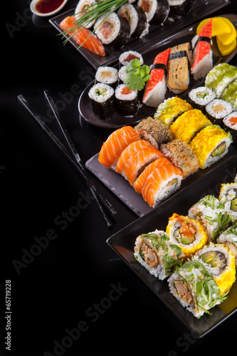 Fotoboard na płycie Pyszne kawałki sushi na czarnym tle