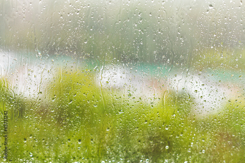 Naklejka na drzwi raindrops on windowpane in summer day