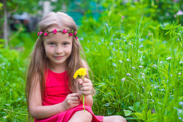 Wall Mural - Portrait of little beautiful girl with flowers in the garden