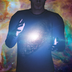 Wall Mural - man holds galaxy between his hands