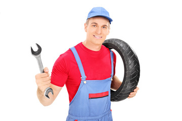 Sticker - Male mechanic holding a wrench and a tire