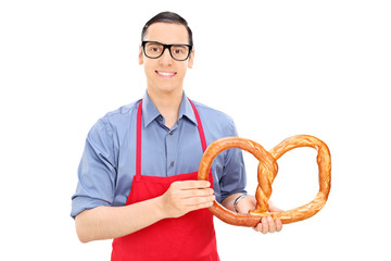 Poster - Male baker holding a huge pretzel