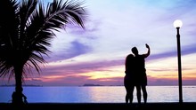 Silhouette Couple  Make Photo Against Sunset