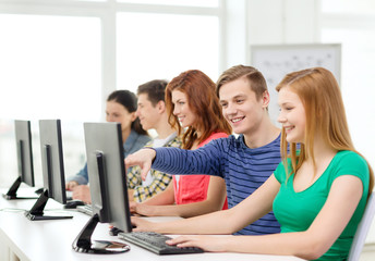 Wall Mural - female student with classmates in computer class