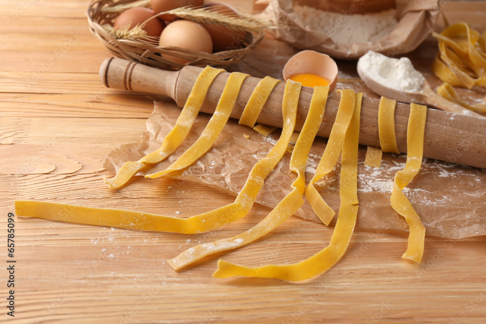 Still life with raw homemade pasta and ingredients for pasta