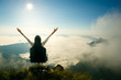 © Patrick Foto - Young woman sits on a chair and open her arms at the top of the