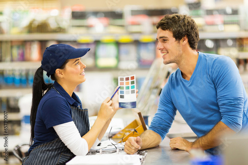 Fotografie, Obraz paint store assistant helping customer choose paint color