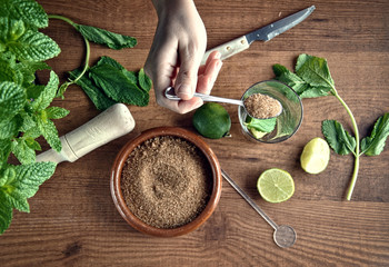 hands preparing mojito cocktail