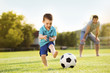 © Halfpoint - Father and son playing football