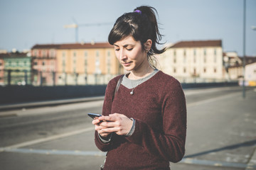 Wall Mural - young beautiful hipster woman using smart phone