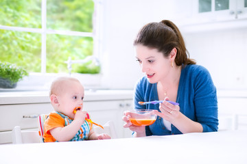 Wall Mural - Baby boy eating his first solid food