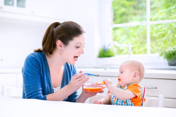 Wall Mural - Baby boy eating his first solid food