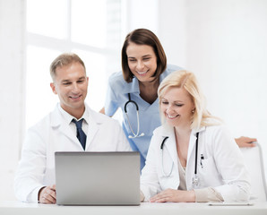 Wall Mural - group of doctors looking at tablet pc