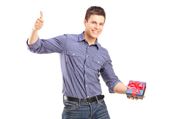 Sticker - Young man holding a present and giving thumb up