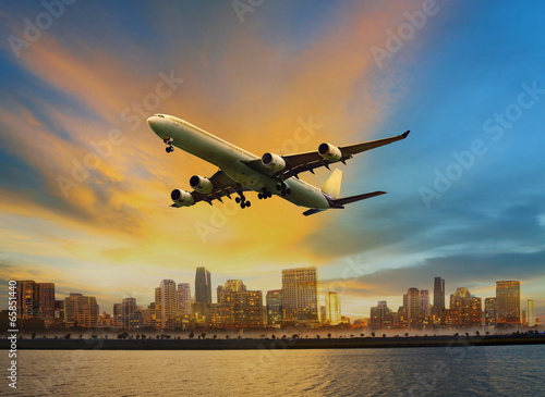 Fototapeta dla dzieci passenger plane flying above urban scene use for convenience air