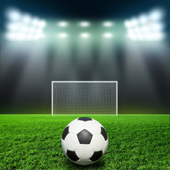 Soccer ball on grass against black background