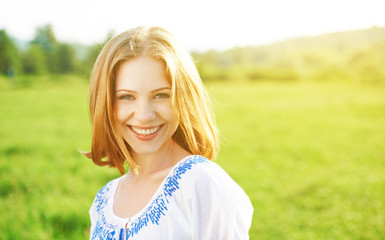 happy beautiful young woman laughing and smiling on nature