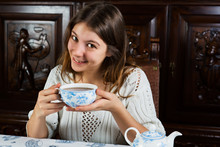 Pretty Young Woman Sitting With A Cup Of Tea