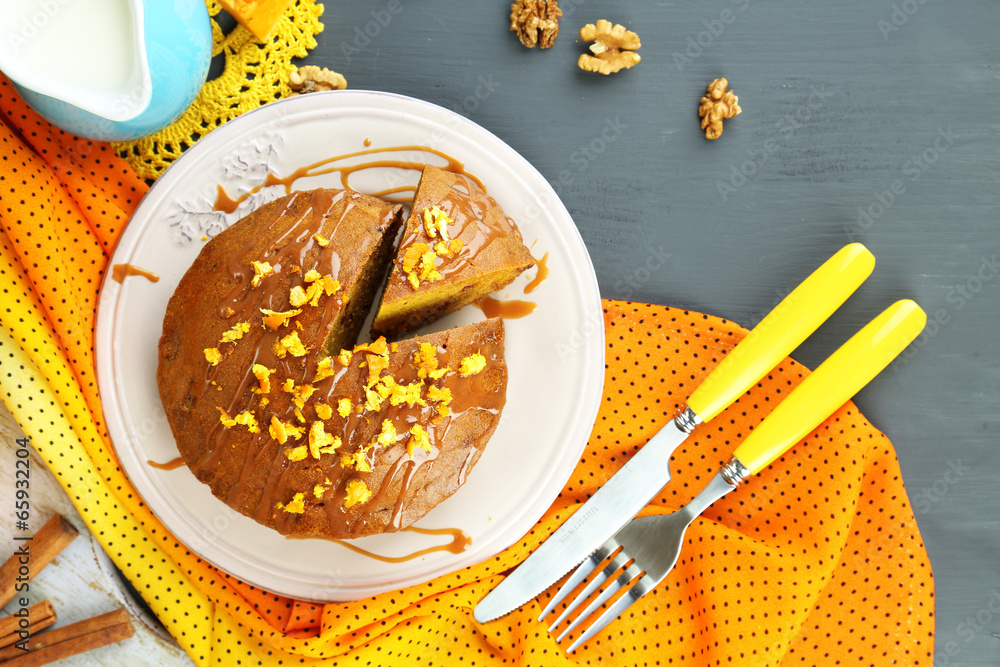 Delicious pumpkin pie on plate on wooden table close-up