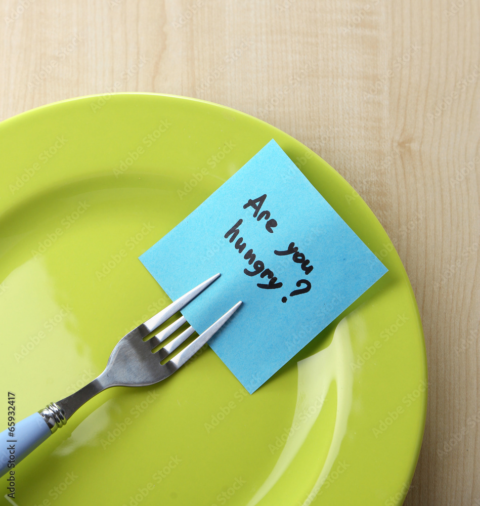 Note paper with message  attached to fork,