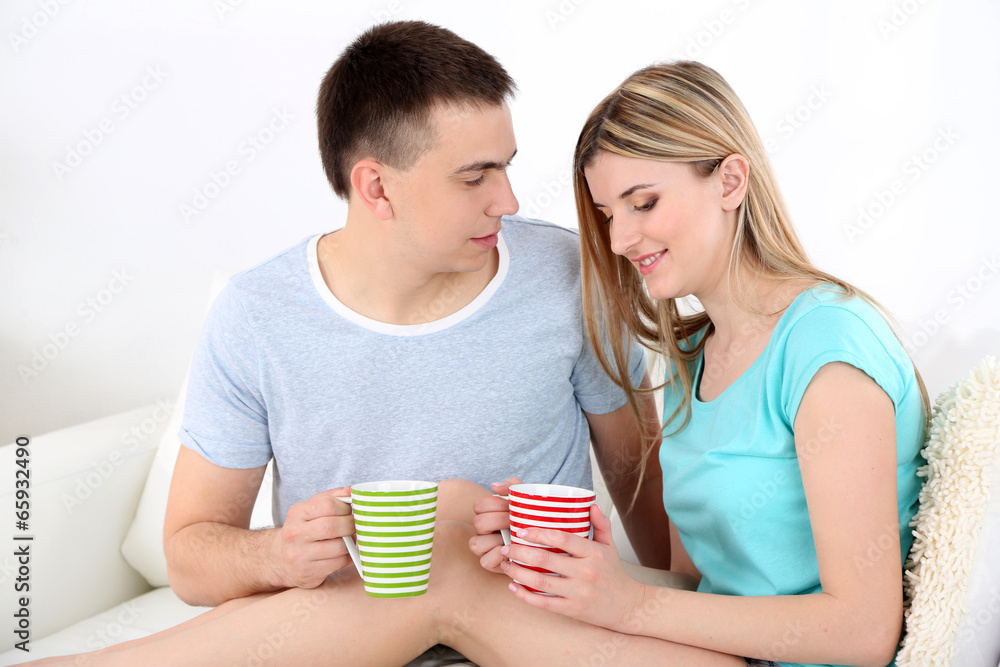 Loving couple sitting  with cups