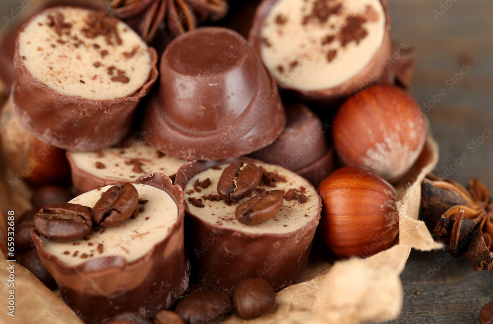 Tasty chocolate candies with coffee beans and nuts, close up