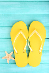 Sticker - Bright flip-flops on color wooden background