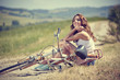 © ZoomTeam - beautiful vintage girl sitting next to bike, summer time