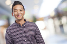 Handsome Young Asian Man Smiling Wearing A Plaid Shirt