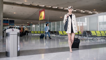 Businesswoman Traveling With Trolley At Charles De Gaulle Airpor