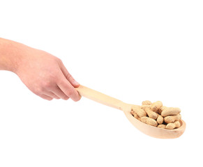 Wall Mural - Hand holds wooden spoon with peanuts.