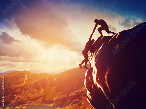 Fotografía Hikers climbing on mountain. Help, risk, support, assistance
