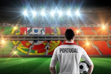 Wall Mural - Composite image of portugal football player holding ball