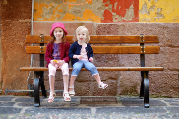 Portrait of two little sisters outdoors