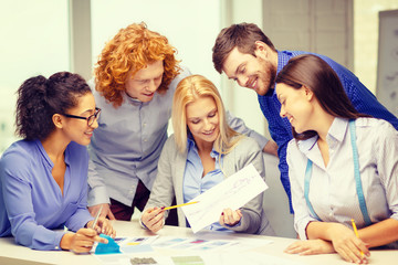 Poster - smiling creative team looking at sketch