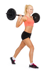 Wall Mural - smiling sporty woman exercising with barbell