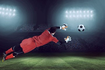 Wall Mural - Composite image of fit goal keeper jumping up