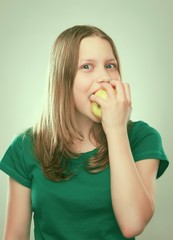 Portrait of a cheerful teen girl with an apple