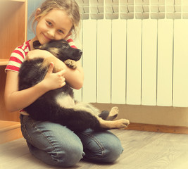 Poster - beautiful little girl and a German Shepherd puppy