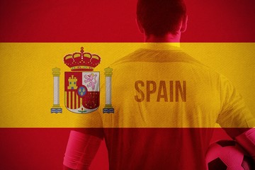 Wall Mural - Composite image of spain football player holding ball