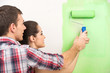 © BlueSkyImages - man helping woman paint wall.