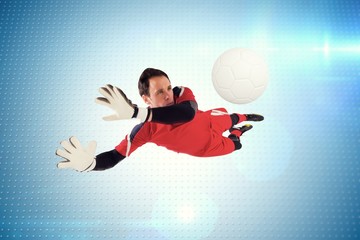 Wall Mural - Composite image of fit goal keeper jumping up