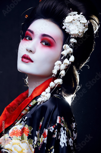 Fototapeta na wymiar geisha in kimono on black