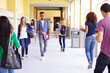 © Monkey Business - Group Of High School Students Walking Along Hallway