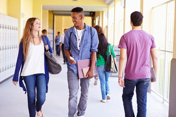 Wall Mural - Group Of High School Students Walking Along Hallway