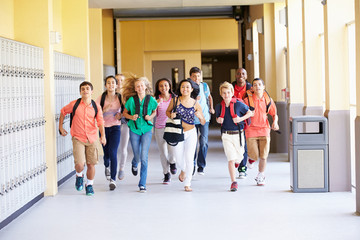 Wall Mural - Group Of High School Students Running Along Corridor