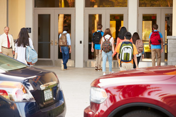 Wall Mural - high school students being dropped off at school by parents