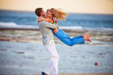 husband holding his wife, the couple just married